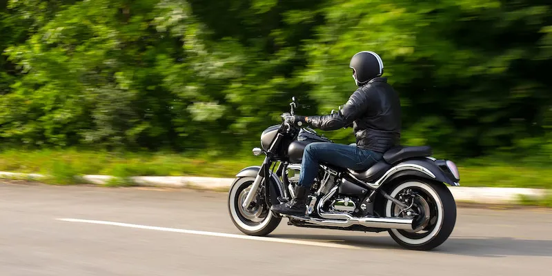 Person in black helmet rides motorcycle on Jacksonville road.