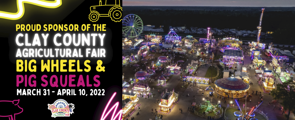 Fairground shining at night, neon graphics and Clay County Fair logo.