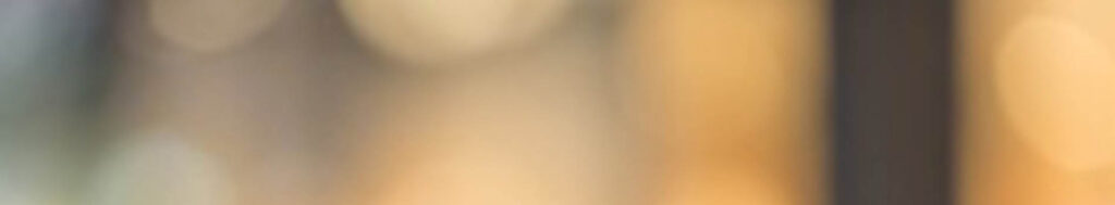 Blurred background with warm yellow, beige, and gray tones.