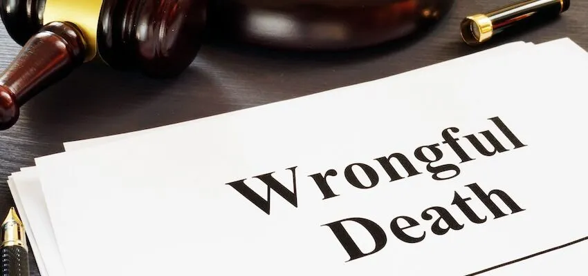 Wrongful Death document with gavel and pen on desk.