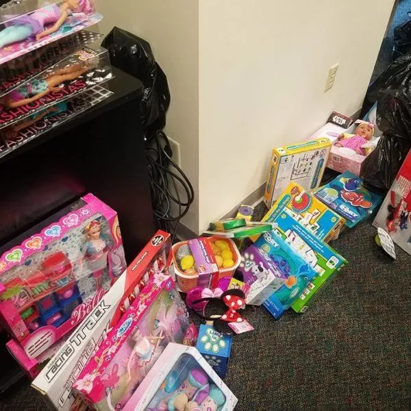 Boxed children's toys and black garbage bags sit on floor.