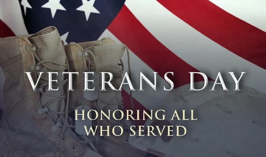 Military boots in front of American flag with Veterans Day text.