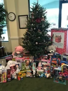 Christmas tree with toys and stuffed animals ready for donation.